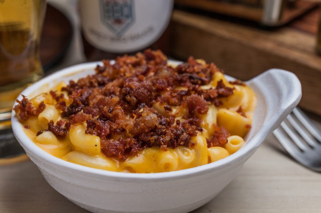 Delicious mac and cheese topped with savory minced meat, a classic side dish from Central City BBQ's barbecue menu.
